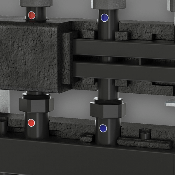 Black heating manifolds with multiple vertical pipes marked with red and blue dots, surrounded by black insulation.